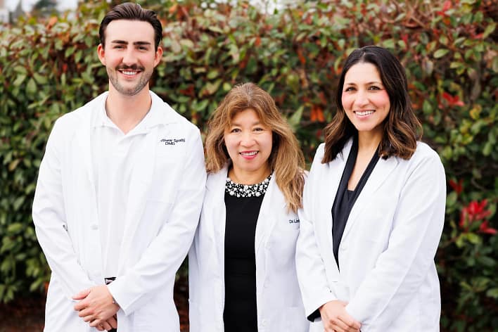 Portrait of dentists from Premier Dental Center in Ferndale, Washington. Dr. Matthew Spalti, Dr. Linh Vu, Dr. Sabina Gill