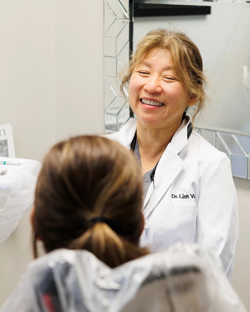 Dr. Linh Vu speaking with a new patient at Premier Dental Center in Ferndale, WA.